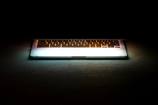 Glowing laptop spotlight dark – luxury digital artwork for the Onyx Edition 1 Month IPTV subscription